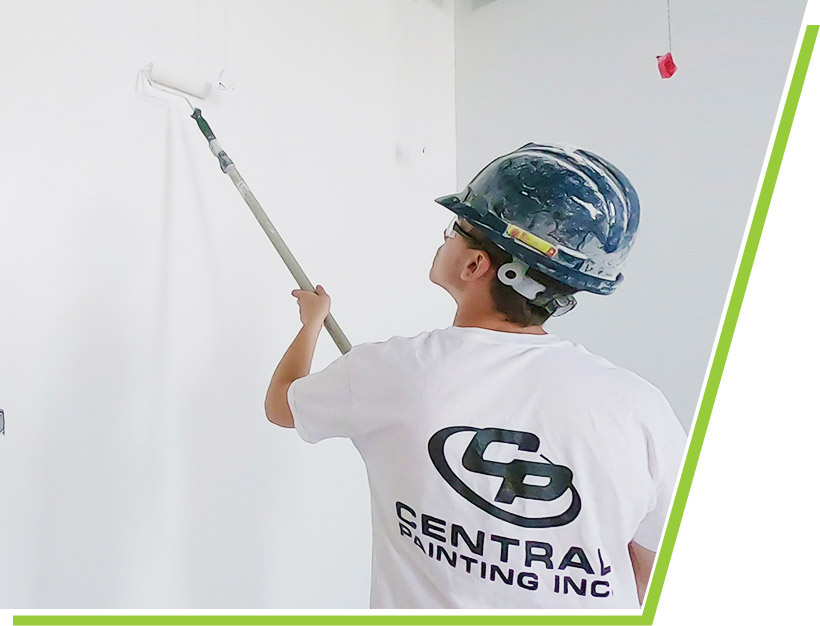Central Painting crew member painting a wall